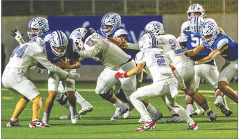 Several Lumberton Raiders defensive players gang up on a Needville running back during last Thursday night’s game at Katy. Brent Guidry photo