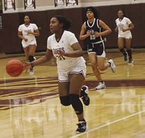 Ayana Washington dribbles the ball up floor with Kearstyn Hall (2) and Ca’Draine Martin following. Silsbee finished District play with a perfect 12-0 record. The Lady Tigers are now 26-3 this season. Dan Eakin photo
