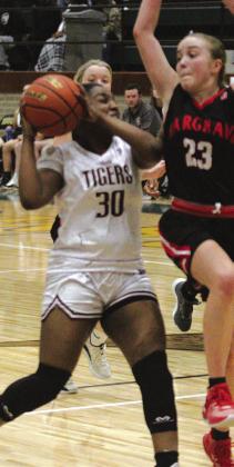 Ayana Washington drives the lane to put up a shot during the Lady Tigers Bi-District win over Huffman Hargrave. The Tigers played well in this game and are hoping to advance far in the playoffs. Danny Reneau photo