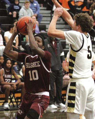 Quinton Shoulders (10) got some valuable playing time against the Vidor Pirates last week. Here he battles his way past Bryce Loftin to put up a shot.Shoulders is a strong offensive player and his skills are quick to see when he hits the floor. Danny Reneau photos