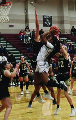 Ca’draine Martin finds a ball in the lane and challenges LCM defenders with a short shot. Martin is the Tigers best rebounder and she is also a great defender who can score against bigger opponents. Dan Eakin photo