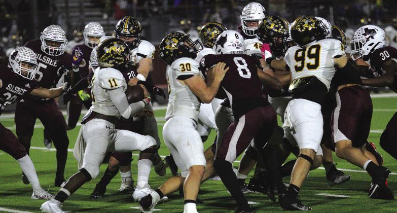 The Gatesville Hornets packed all their offensive players into a small space and then smashed Rayshon Smith (11) into their midst.The much smaller Tiger team managed to come up with a plan to defend the hard running Hornets. Silsbee only allowed one TD in a 35-10 victory in the area round of the Play offs Smith carried the ball 19 times in the first half against Silsbee and caught a couple of passes. Photos by Danny Reneau