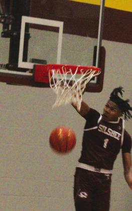 Jared Harris dunks a ball against the Beaumont United Timberwolves on Monday. Harris who plans to attend Memphis University next year led the Tigers with 21 points. Danny Reneau