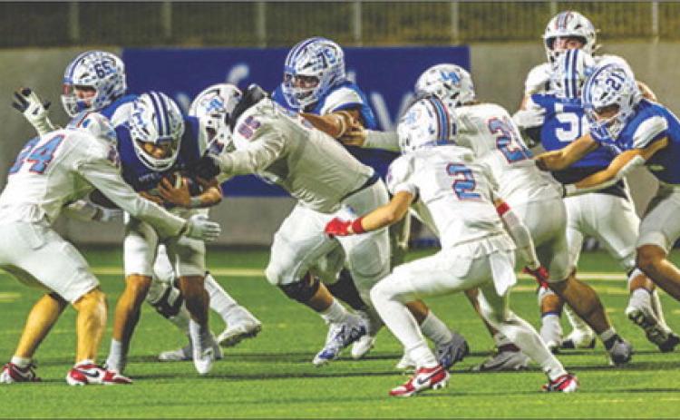 Several Lumberton Raiders defensive players gang up on a Needville running back during last Thursday night’s game at Katy. Brent Guidry photo