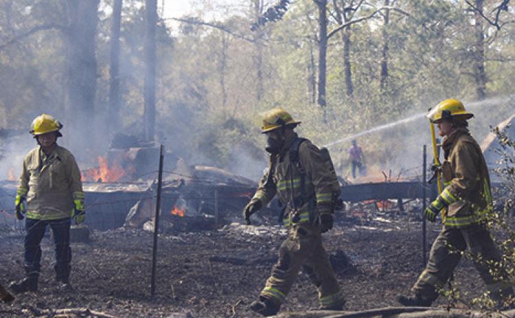 Silsbee and Kountze firefighters went to the 5200 block of Airline Road last Wednesday afternoon where fire had burned an unoccupied trailer house and had spread to trees nearby. Dan Eakin photo
