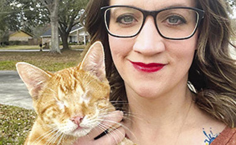 Lexi Swindell, founder of the Satsuma Valley Cat Coalition (SVCC), holds Milo,a tabby cat whose eyes had to be removed because of a serious disease. Courtesy photo